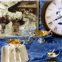 A silver cream pitcher, sugar bowl and tray, a glass sugar bowl and glass mugs, a clock, and a picture