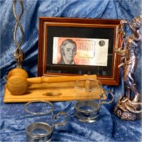 A selection of gift products such as a clock, candlesticks, a photo frame, glass mugs, and a small statue