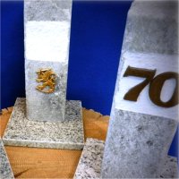 Three different styles of carved stone birthday memorabilia