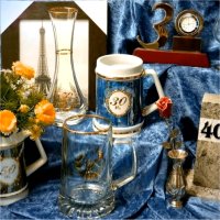 Different styles of birthday gift products such as drinking stoups and glasses, a vase, a clock, a picture frame, and a metal rose