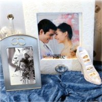 Different types of wedding gifts such as a photo album, metal rose, photo frames, and a shoe-shaped stand for rings