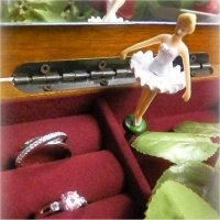 Different styles of silver rings in a music box with a ballerina