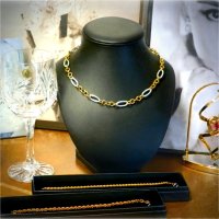 Gold necklaces and bracelets, pictures, and crystal glasses