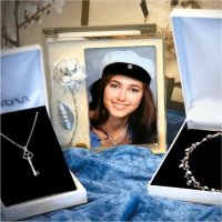 Silver necklaces in jewelry boxes and a graduation photo album