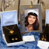 Gold necklaces and earrings in jewelry boxes and a graduation photo frame