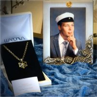 A couple of mens' necklaces and a graduation photo frame