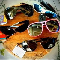 Different styles of sun glasses for adults and children