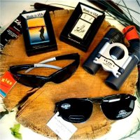 Different kinds of outdoor products such as sun glasses, some lighters, and a pair of binoculars